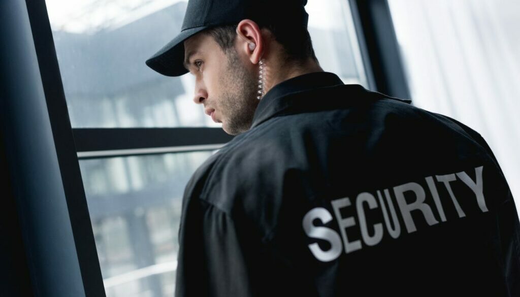 rear-view-of-handsome-guard-in-uniform-with-earphone.jpg